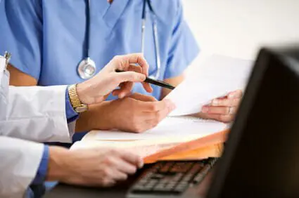 Construction Accident Leads to Leg Amputation 1 Doctor and nurse reviewing paperwork