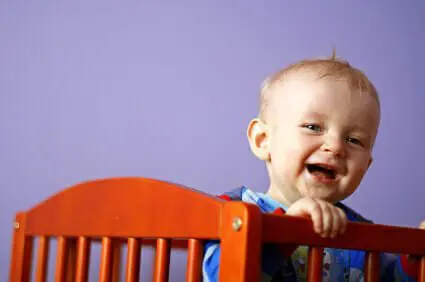 Toys ‘R’ Us Recalls Pacifier Clips Due to Choking Hazard 1 Baby boy smiling in crib