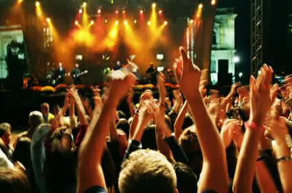 Woman Files Lawsuit After Being Struck by Drum Stick at a Styx Concert 1 Crowd in blur at a rock concert.