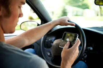 What is Distracted Driving? 1 Man driving a car while using a cell phone with one hand.