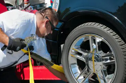 Blog 6 Tow truck driver strapping car down