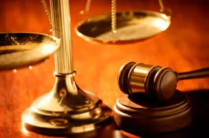 Golden scales and gavel on wood desk