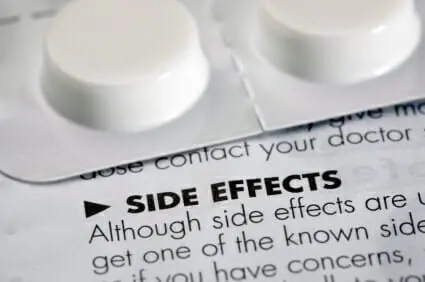 Blog 12 Side effects leaflet with a tablet container sitting on top