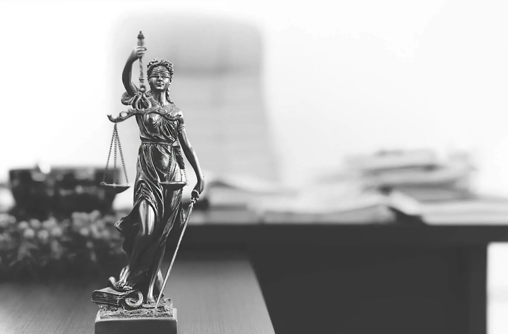 Statue of Themis holding scales of justice in lawyer's office