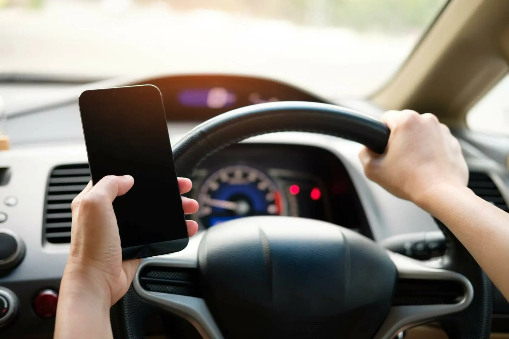Driver holding cellphone while driving