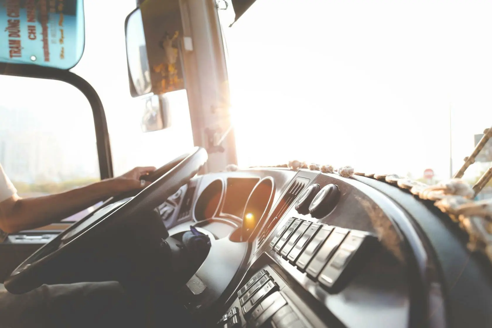 Blog 15 Public transit bus dashboard with driver's and holding the steering wheel