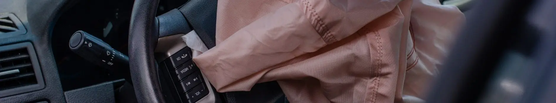 Blog 4 Close-up of steering wheel with pink airbag deployed