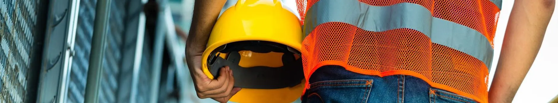 Texas Work Zone Traffic Deaths Reach 40-Year High 1 Construction worker with orange reflective safety vest holding yellow helmet