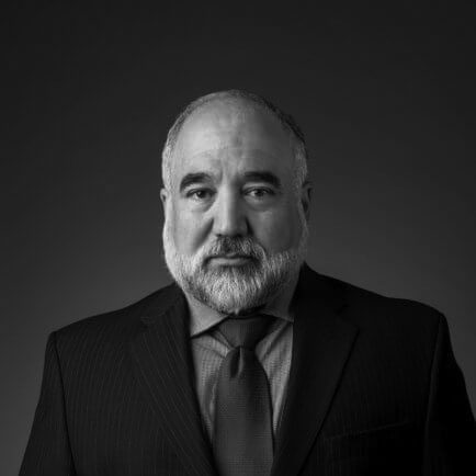 Black and white portrait photo of Thomas J. Henry Attorney Xavier Guerra