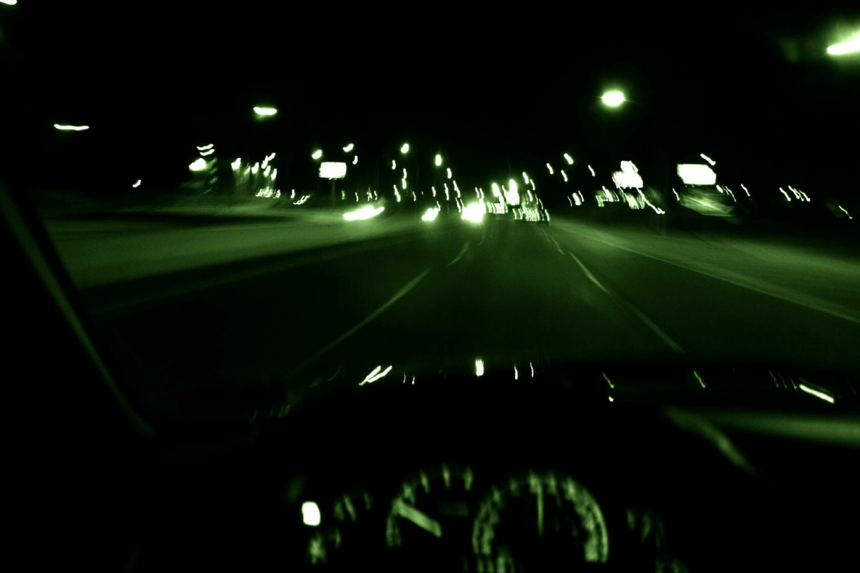 Blurry green tint image of driving