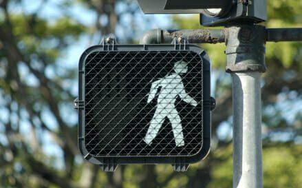 Pedestrian crosswalk signal with walk illuminated