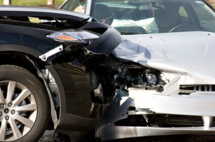 A black car and white car damaged in a crash