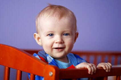 smiling infant in crib