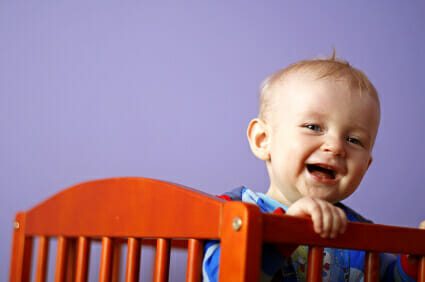 Baby boy smiling in crib