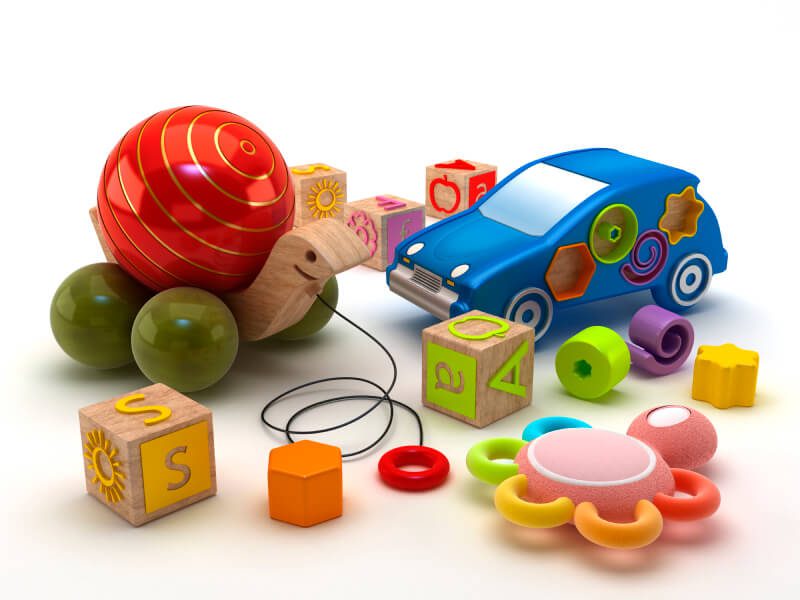Group of child and infant toys including blocks, rattle, and pull toy