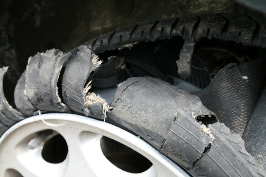 Close up of a destroyed car tire.
