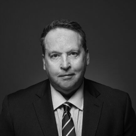 Black and white portrait photo of Thomas J. Henry Attorney L. Brent Farney