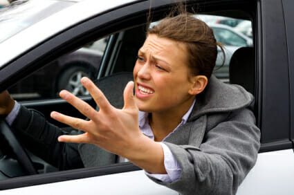 Angry driver frustrated leaning outside of car window