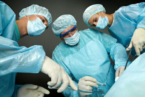 Bottom view of three surgeons operating