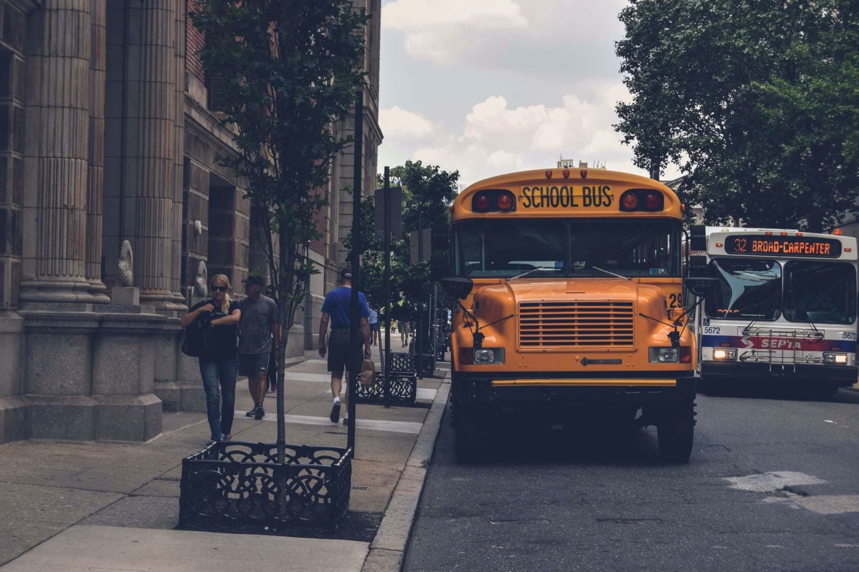 School bus parked on side of street near sidewalk