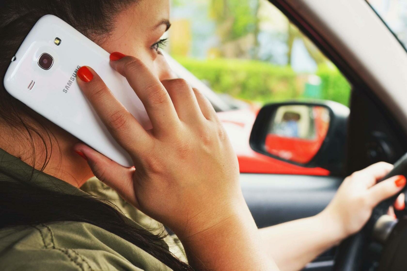 Woman talking on Samsung phone while driving