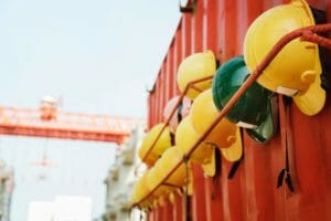 Construction safety helmets hung on side of shipping container