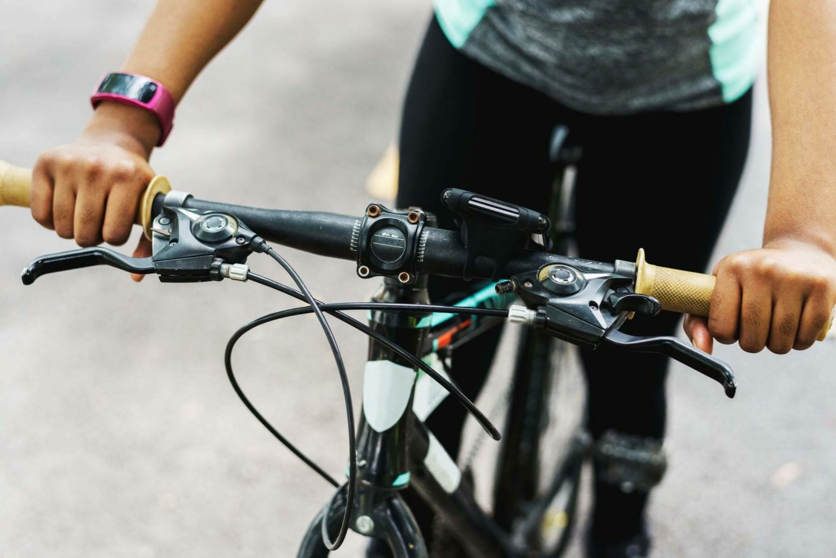 Cropped shot of a woman holding her bicycle handle