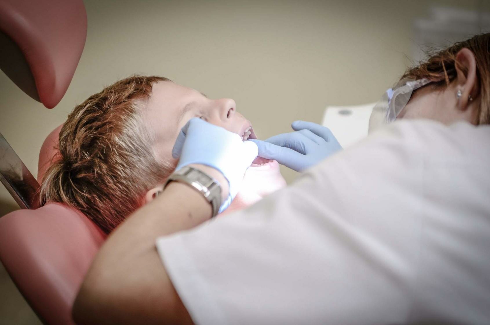 Dentist looking into child's mouth