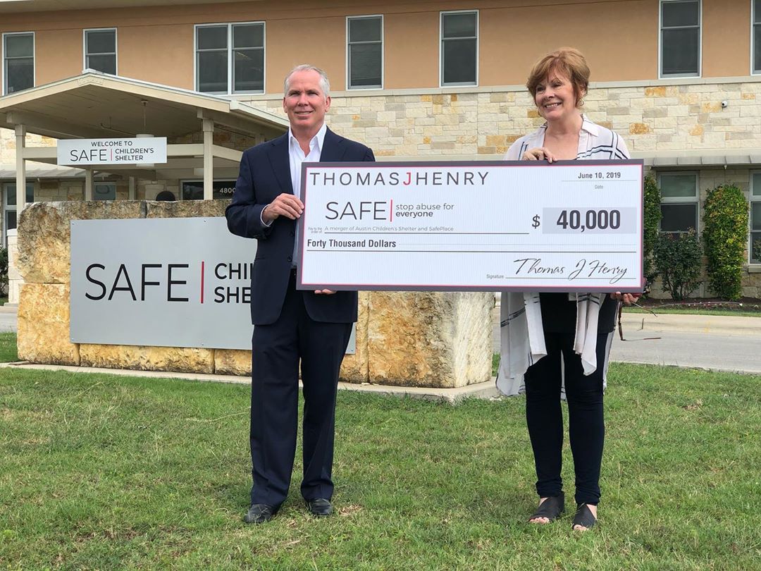 Thomas J. Henry presents a donation check to SAFE